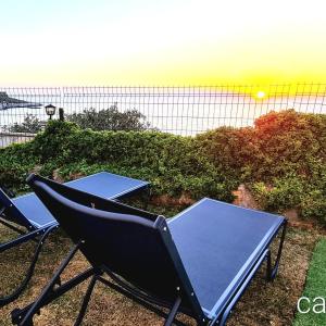 two chairs and a ping pong table on a patio at Denize sıfır benzersiz villa in Kusadası