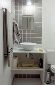 a bathroom with a sink and a toilet at Casa Saga - All Suites in Rio de Janeiro
