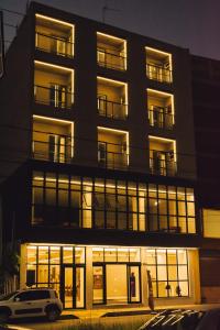 a building with a car parked in front of it at Britto Hotel in Aparecida +15 photos