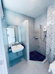 y baño con lavabo y ducha. en Remas Hotel Hatyai en Hat Yai