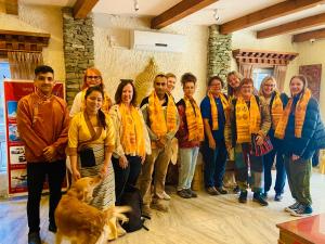 a group of people posing for a picture with a dog at Three Jewels Boutique Hotel in Pokhara
