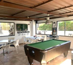 a pool table in a restaurant with tables and chairs at LagoVista45 in Torrevieja