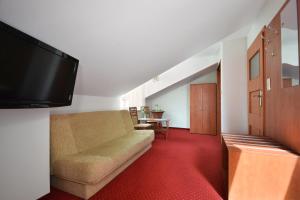 a living room with a couch and a flat screen tv at Villa del Marco in Rewal