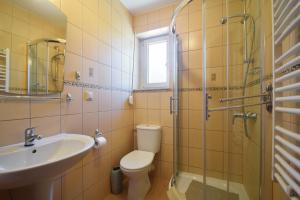 a bathroom with a toilet and a sink and a shower at Villa del Marco in Rewal +62 photos