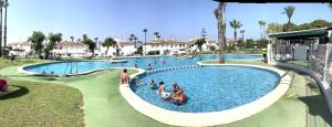 a group of people in a swimming pool at a resort at LagoVista45 in Torrevieja