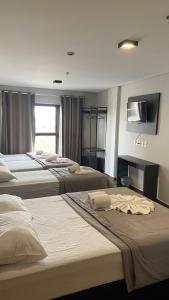 מיטה או מיטות בחדר ב-Britto Hotel