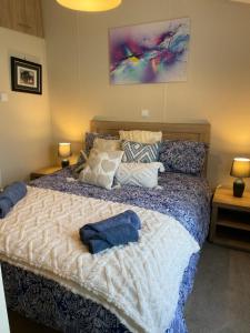 a bedroom with a large bed with pillows on it at Nodes Point Sandy Bay AP27 affordable ferry prices available in Saint Helens