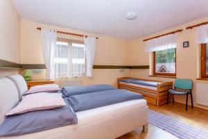 A bed or beds in a room at Penzión Javor