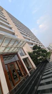 a tall building with windows on the side of it at New 1BHK at Central Park, Sohna Road, Ayaansh Resort in Gurgaon