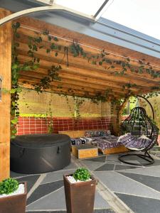 a patio with a pergola with plants on it at Barok in Tešanj