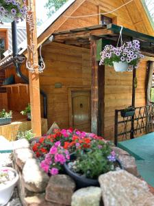 a flower garden in front of a wooden house at NINO Natural wood house in Visoko