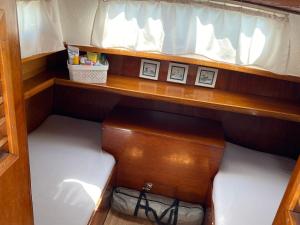 a cabinet in a boat with two shelves at Boat Albatros - kamperen op het water - niet om mee te varen - read host profile-lees hostprofiel in Jutrijp