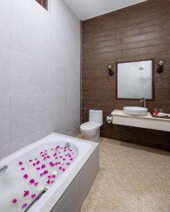 La salle de bains est pourvue d'une baignoire, de toilettes et d'un lavabo. dans l'établissement Fushi Beach Guesthouse, à Fenfushi