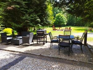 a group of chairs and tables in a park at Leśne Zacisze in Głogów Małopolski