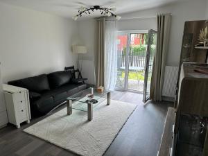 a living room with a black couch and a table at Villarina in Dresden