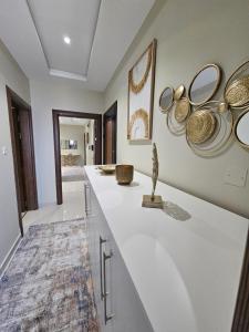 a kitchen with a counter with plates on the wall at الشقق الفاخرة Modern Apartments of 3 Bedrooms 5 minutes to Haram in Al Madinah +290 photos