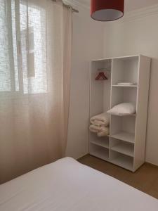 a bedroom with a white bed and a window at Well being point in Agadir