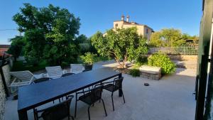 a large black table and chairs on a patio at Villa Dina in Tar