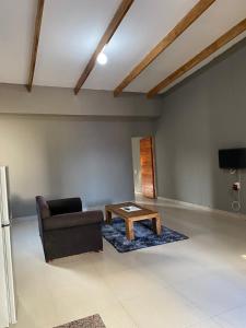 a living room with a couch and a coffee table at Onothweni Lodge in Manguzi