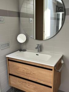 a bathroom with a sink and a mirror at Appartamento Scoggione in Colico +37 photos