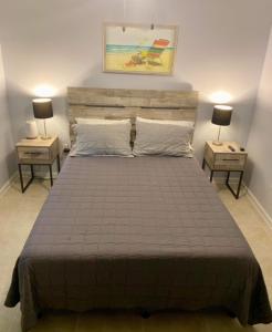 a bedroom with a large bed with two night stands at Gulf Shores Surf & Racquet Club 212A in Gulf Shores