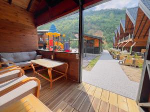 a screened in porch with a table and a playground at Aquarium BUNGALOW UZUNGÖL in Uzungol