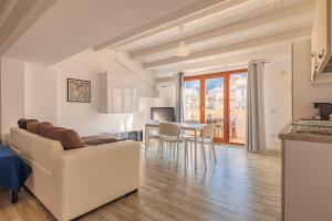 a living room with a couch and a table at Marina di Petrolo Apartments in Castellammare del Golfo