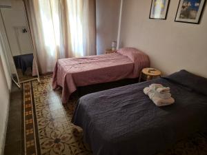 a hotel room with two beds with shoes on them at Apartment Trapani's heart in Trapani