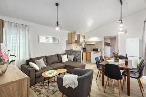 a living room with a couch and a table at Apartman Tromba near the Sea in Šišan +23 photos