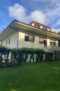 a large white house with a green yard at Casa El Hoyuco in Lamadrid