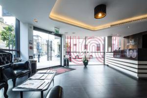 a restaurant with a table and chairs and a window at The Whitechapel in London
