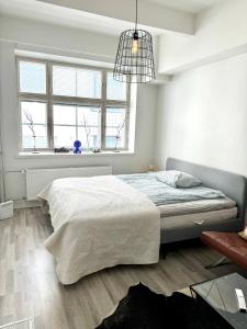 a bedroom with a bed and a pendant light at Factory Studio in Helsinki