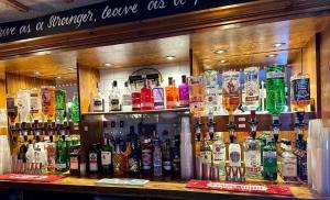 a bar filled with lots of bottles of alcohol at Ye Olde Vaults in Ashbourne