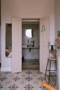 a bathroom with a sink and a mirror at L'Orangeraie d'Afa in Afa