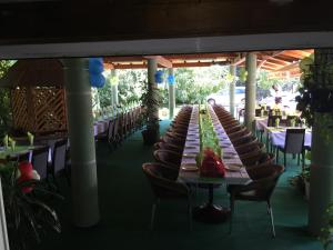 a long row of tables and chairs on a patio at Bed & Breakfast Karavan in Raška
