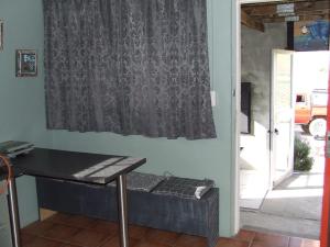 a room with a table and a curtain on a wall at Eltos Karoo Stay Guest Farm in Laingsburg