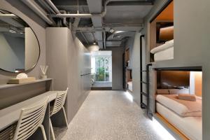 a room with bunk beds and a mirror at Tiang Studio in Bangkok