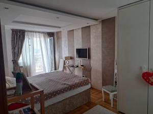 a small bedroom with a bed and a window at Lux Apartman 7 in Voždovac