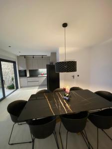 a dining room with a black table and chairs at Villa 5 in Makarska