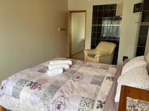 a bedroom with a bed with two towels on it at Papli Apartment near the Beach in Pärnu