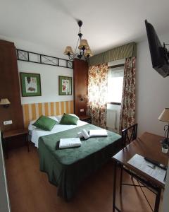 um quarto de hotel com duas camas e uma mesa em HOSTAL RURAL ALTO TAJO POVEDA em Poveda de la Sierra