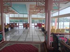 a room with tables and chairs in a building at Canopy Nexus Resort Over The River in Gilgit