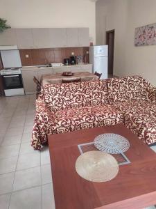 a living room with a couch and a table at Beautiful apartment ANAIS near the sea in Agia Triada