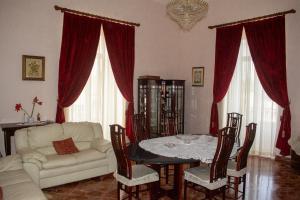 a living room with a white couch and a table at Palazzo San Francesco in Scorrano