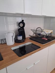a kitchen counter with a coffee maker and a clock at T2 Proche du port, zone piétonne in Toulon