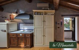 a kitchen with a white refrigerator and a sink at Il Borghetto Vacanze nei Mulini in Valeggio sul Mincio