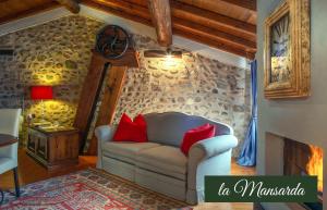 a living room with a white couch and red pillows at Il Borghetto Vacanze nei Mulini in Valeggio sul Mincio