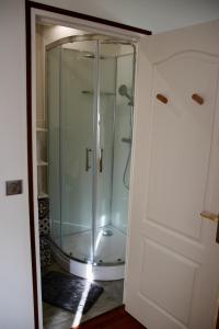 eine Glasdusche im Bad neben einer Tür in der Unterkunft La Villa Mirabelle 2min d'Arromanches-les-Bains in Tracy-sur-Mer