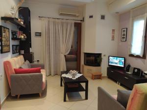 a living room with a couch and a table at Seafront dream Villa, Ierissos in Ierissos