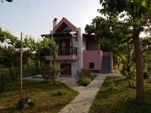 a house with a driveway in front of it at Seafront dream Villa, Ierissos in Ierissos